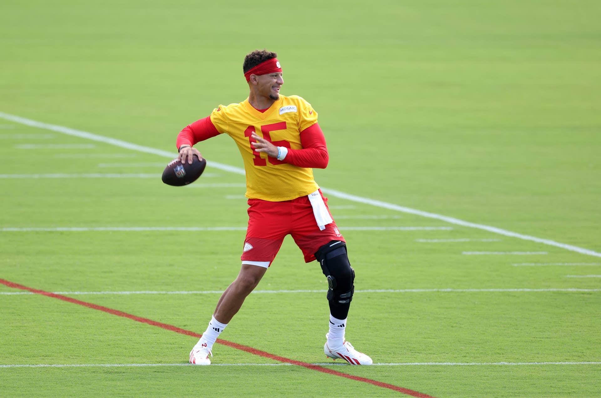Patrick Mahomes throwing at Kansas City Chiefs training camp in 2026 with a knee brace
