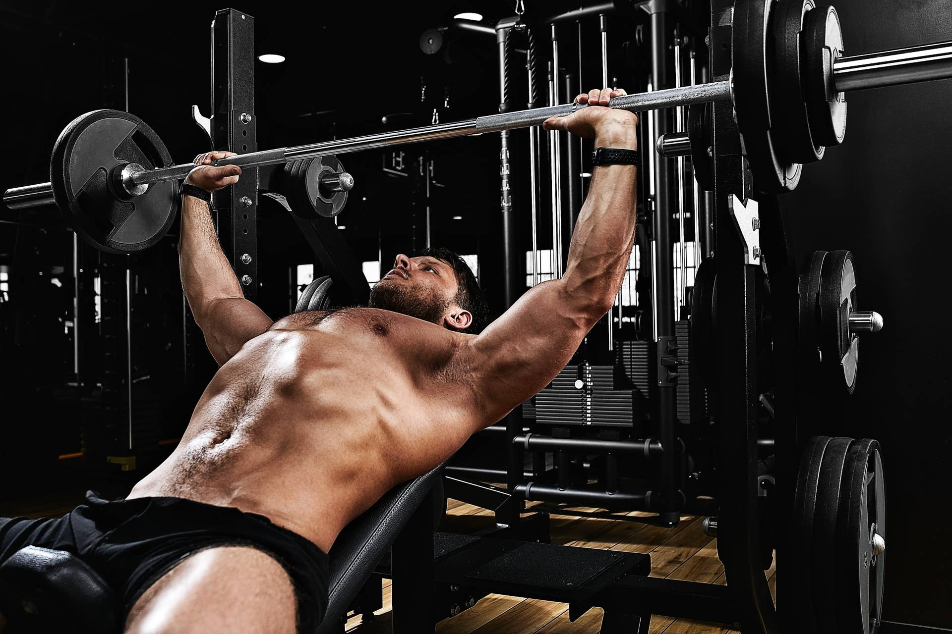 A muscular man showcasing a well-developed, full upper chest and front shoulders after a targeted bodybuilding hypertrophy program.